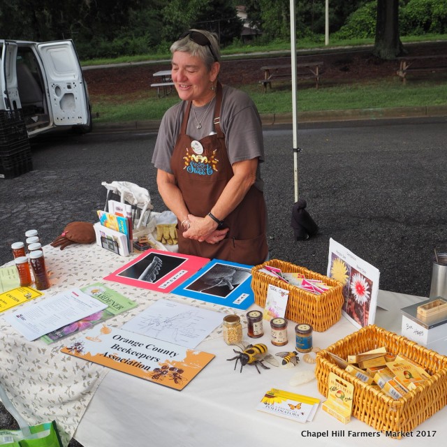Chris Apple offers information about beekeeping at the market.